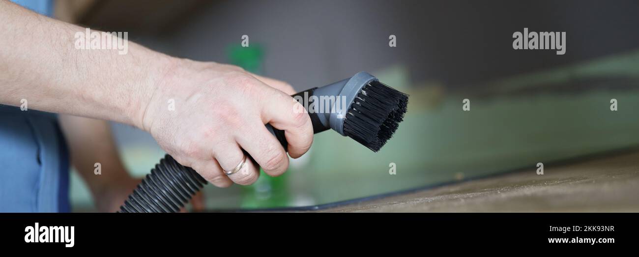 Male worker remove dust with vacuum cleaner, nozzle on cleaning device Stock Photo Alamy