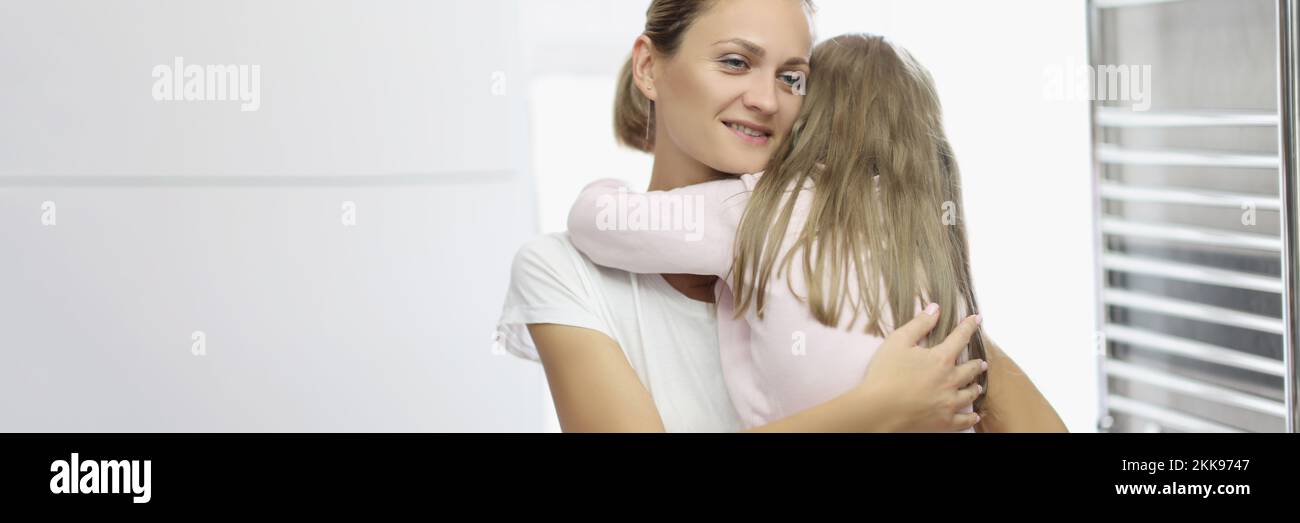 Mother and daughter hugging, mother comfort daughter in arms Stock Photo