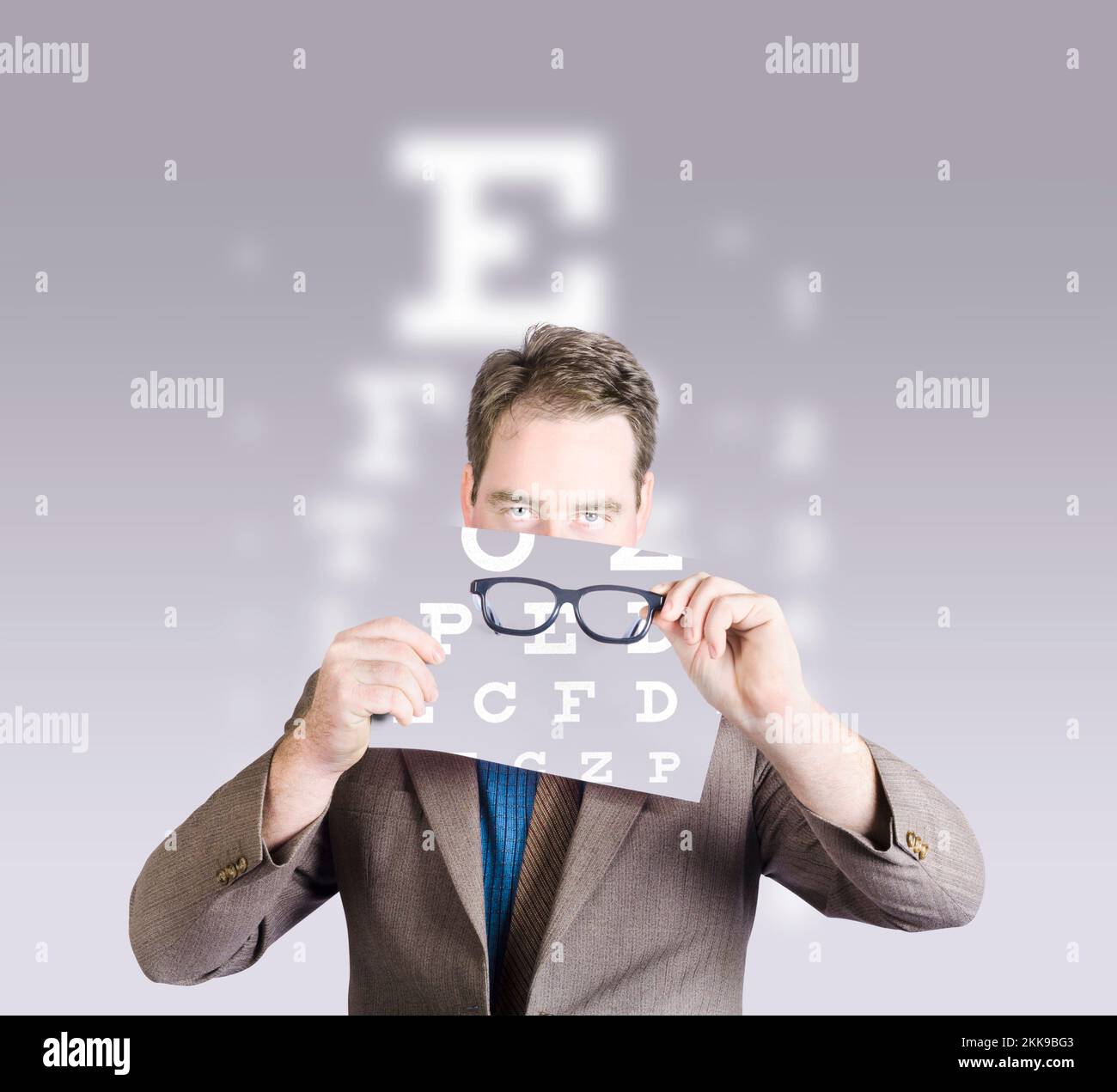 Optometrist or vision doctor holding eye glasses in front of eye examination test chart. Vision