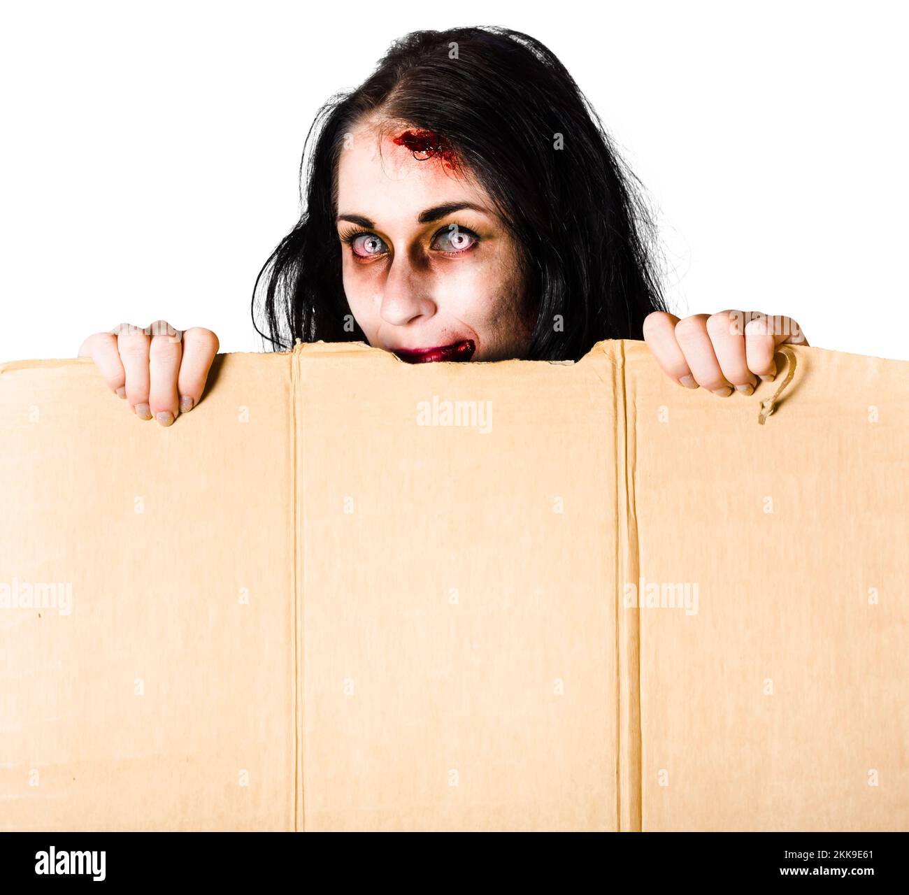 Zombie woman with injuries peering out of cardboard box at Halloween
