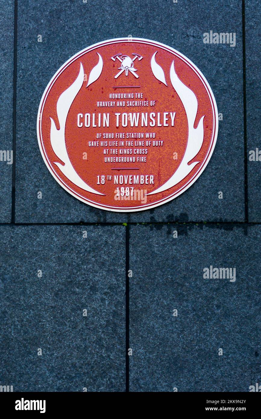 A red plaque at King's Cross railway station in memory of Colin Townsley, a fireman who died in the 1987 King's Cross underground fire. Stock Photo
