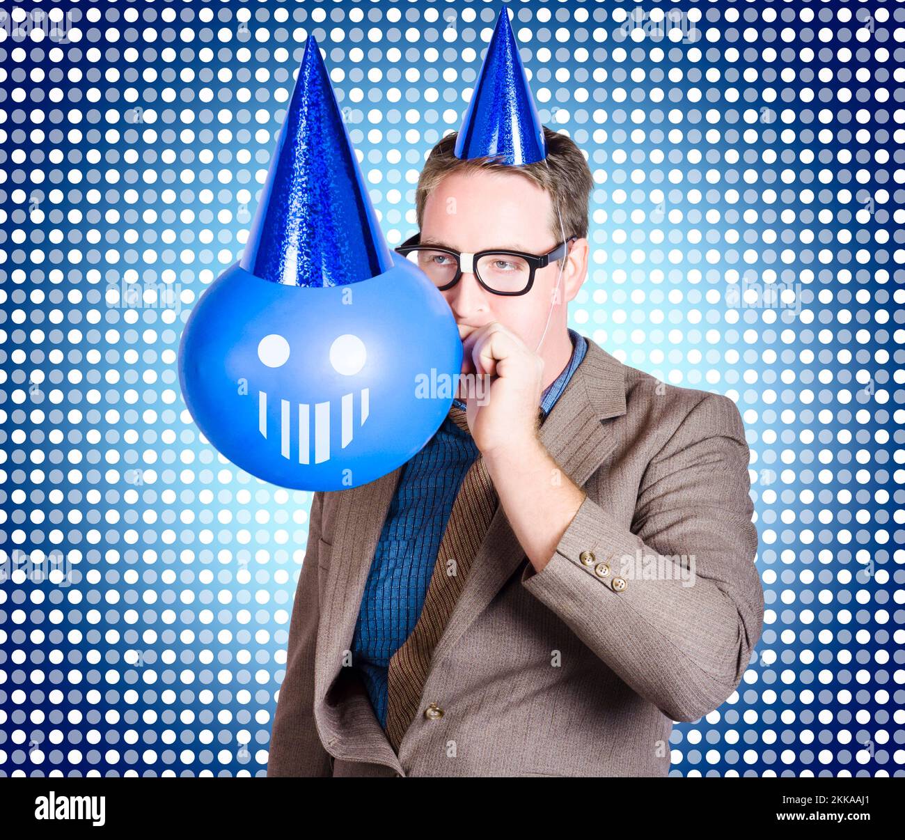 Quirky portrait of a funny businessman wearing birthday party hat while ...
