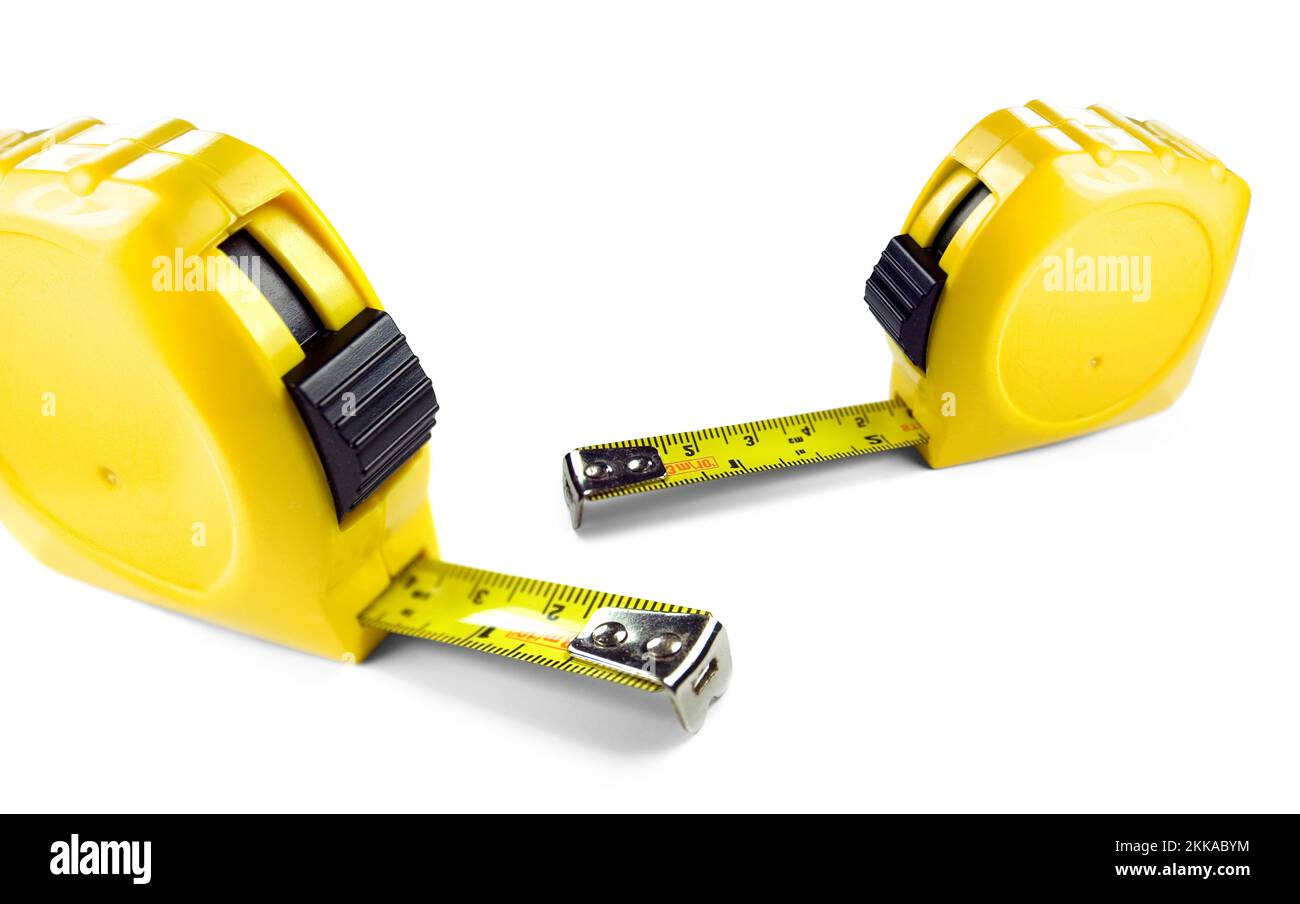 Yellow tape measure showing imperial and metric scale, isolated on