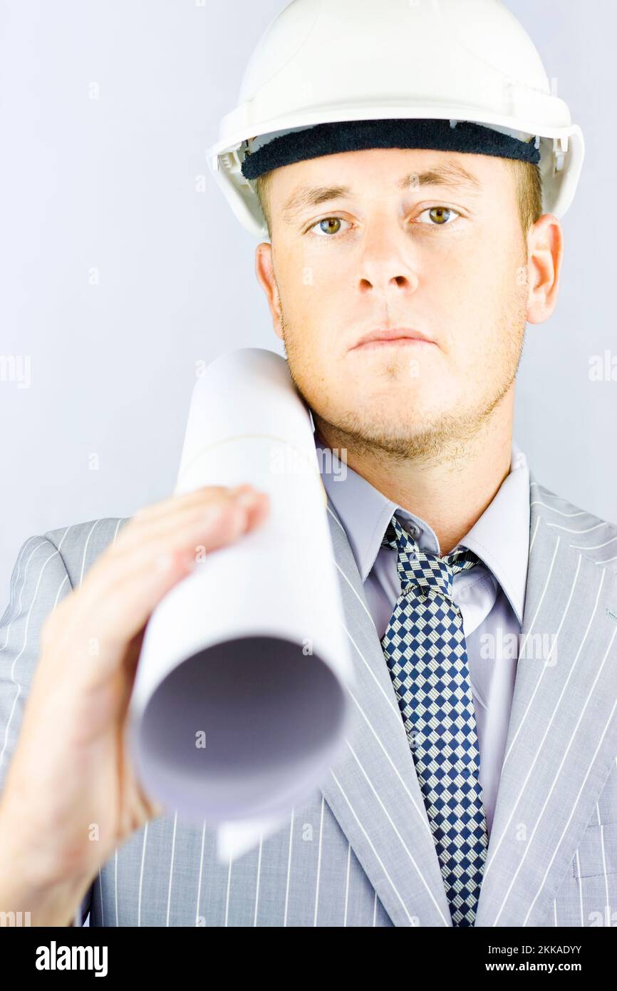 Young electrical engineer wearing a safety hard hat walking to the