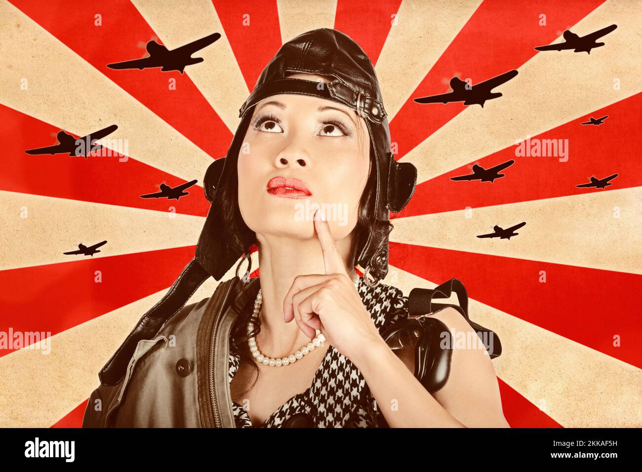 Retro propaganda take-off. Asian pinup freedom fighter looking up to the skies of revolution to scout the war planes of liberation Stock Photo