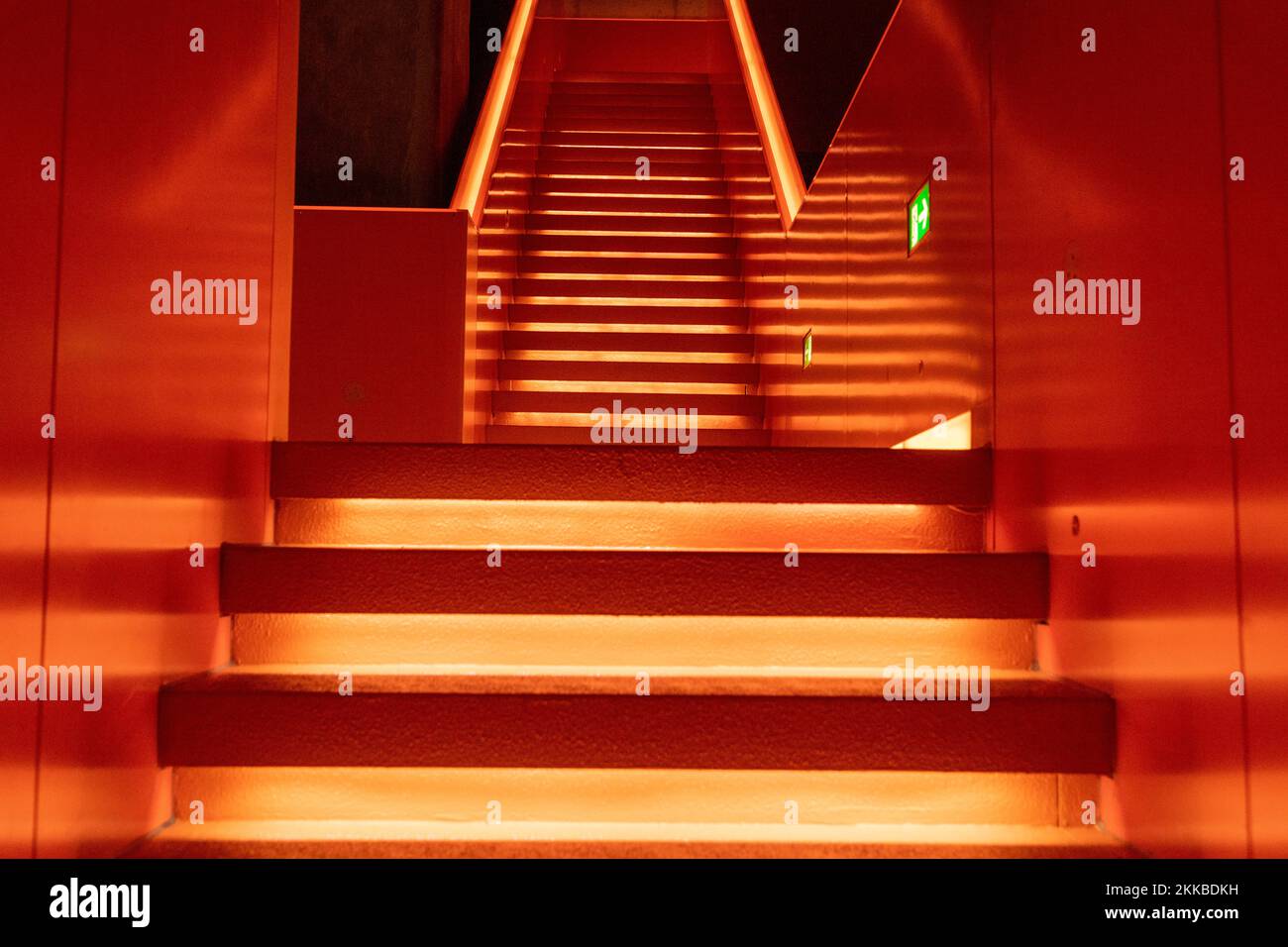 Essen, Germany - July 23, 2019:  Interior view of beautiful orange illuminated remarkable staircase is located at the entrance of Ruhr museum at Zeche Stock Photo