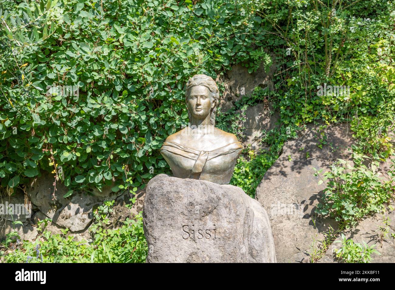 Meran, Province Bolzano/Italy - August 5, 2019: Monument of Queen and Empress Sissi or Sisi in flowerbed. Located in, Die Gaerten von Schloss Trauttma Stock Photo