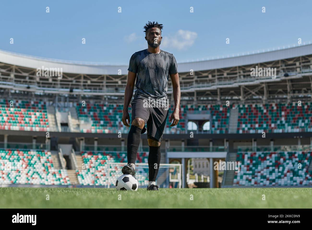 african american man holding a soccer ball in the stadium Stock Photo ...