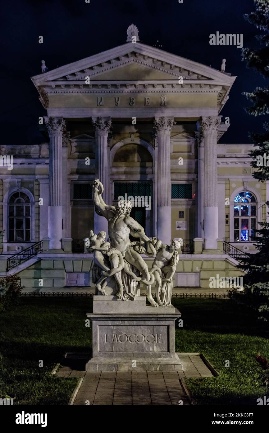 A vertical shot of Laocoon and His Sons statute at night with colorful lights Stock Photo