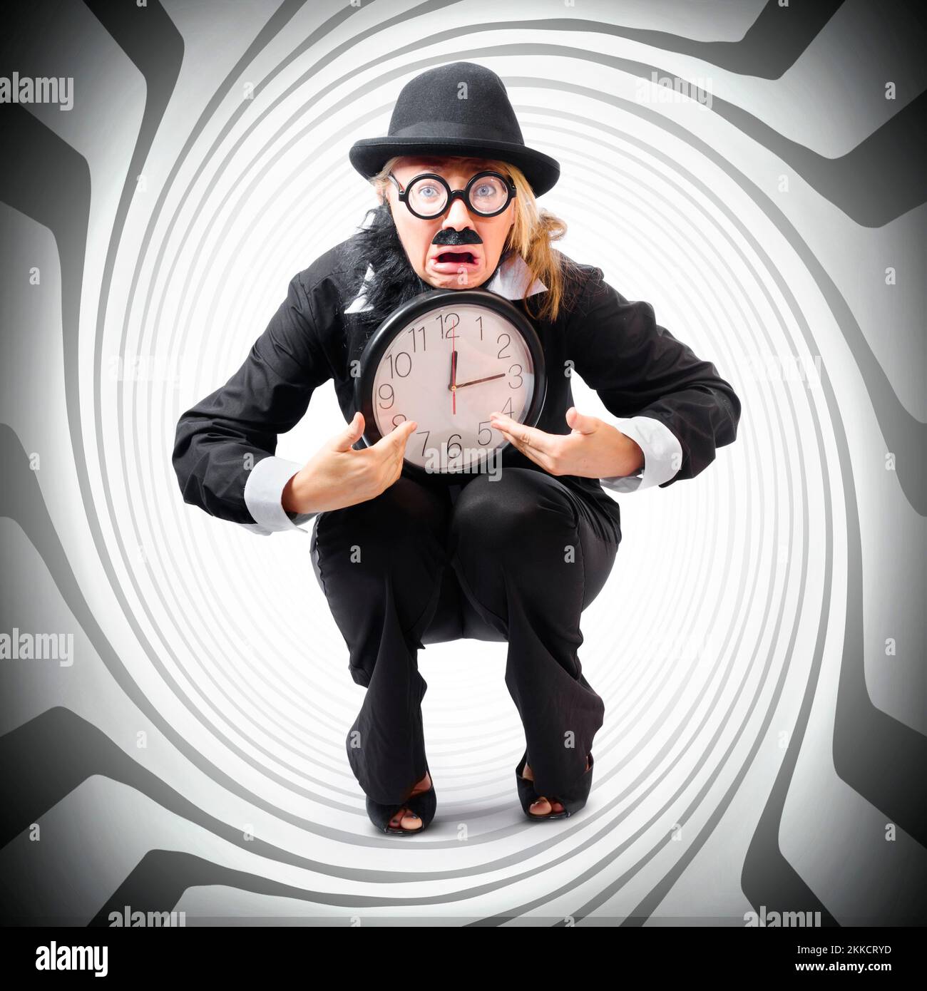 Vintage business man holding clock while stuck in a tight time pressured schedule. Time crunch