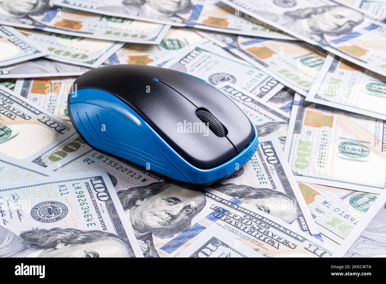 Computer mouse on dollars background. Click fraud concept Stock Photo