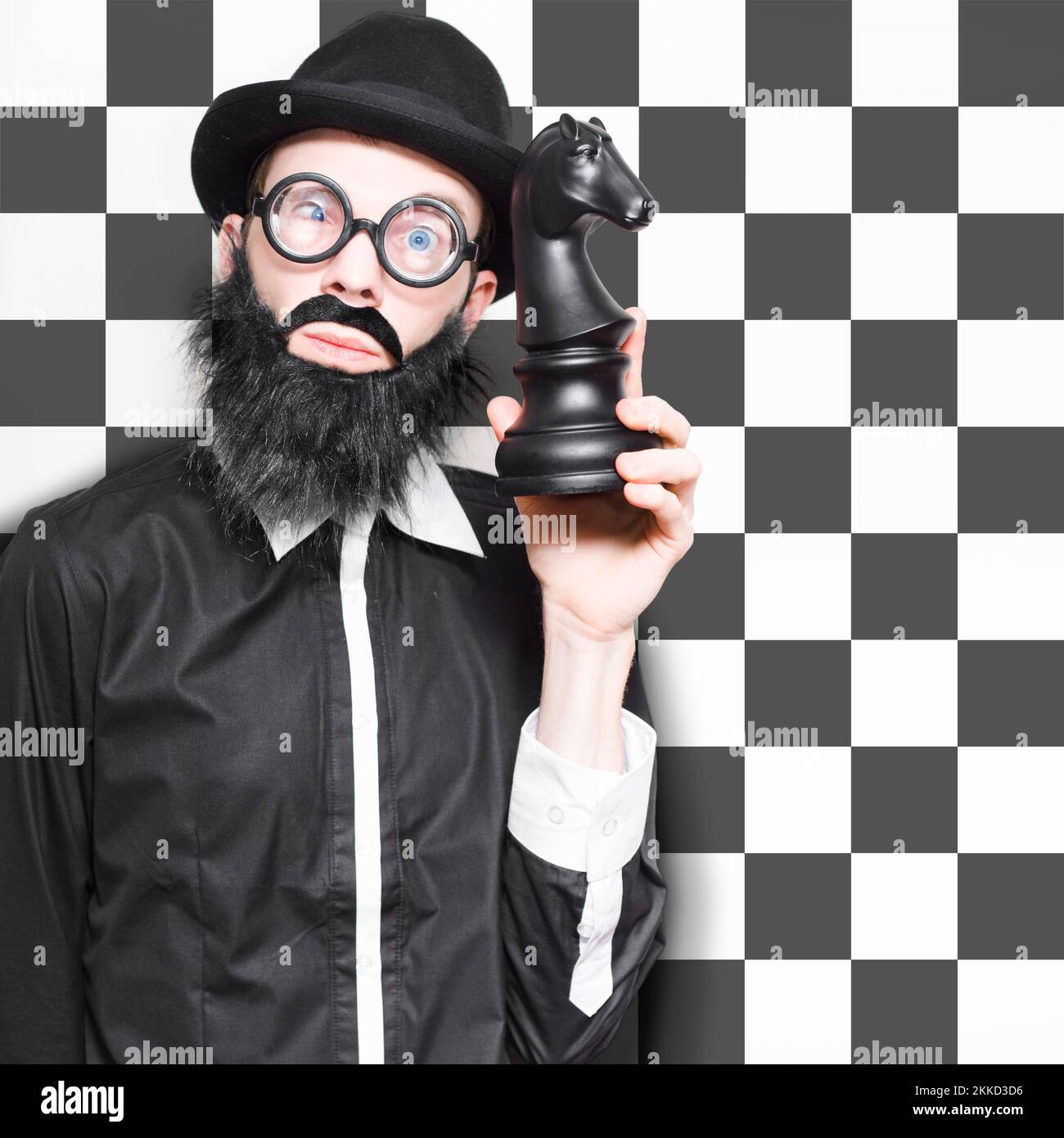 Smart Male Business Analyst Thinking And Devising A Market Strategy Plan While Moving A Giant Chess Game Piece, On Black And White Background Stock Photo