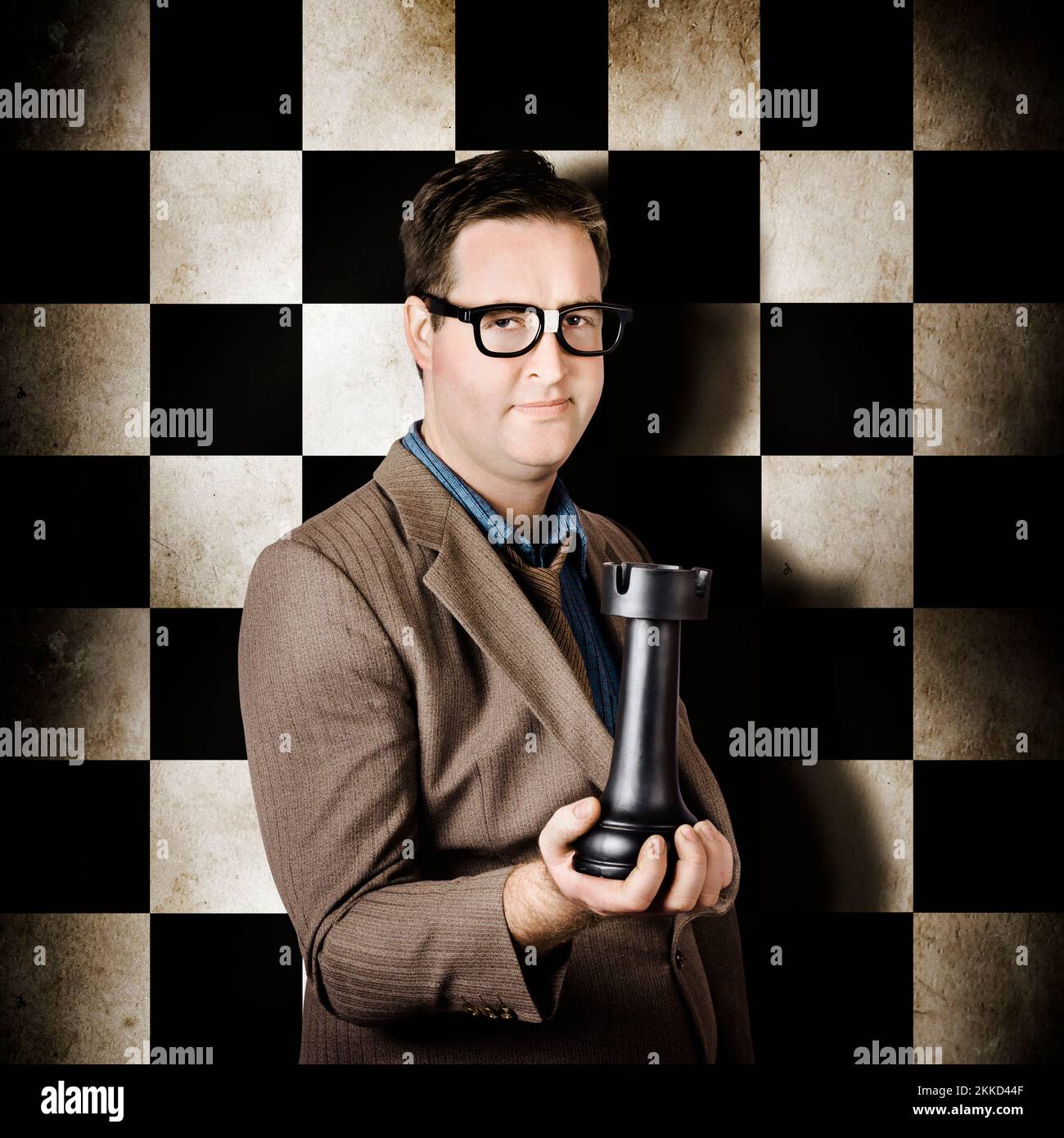 Thinking business man holding strategy chess piece when in a leadership challenge. Competition in management Stock Photo