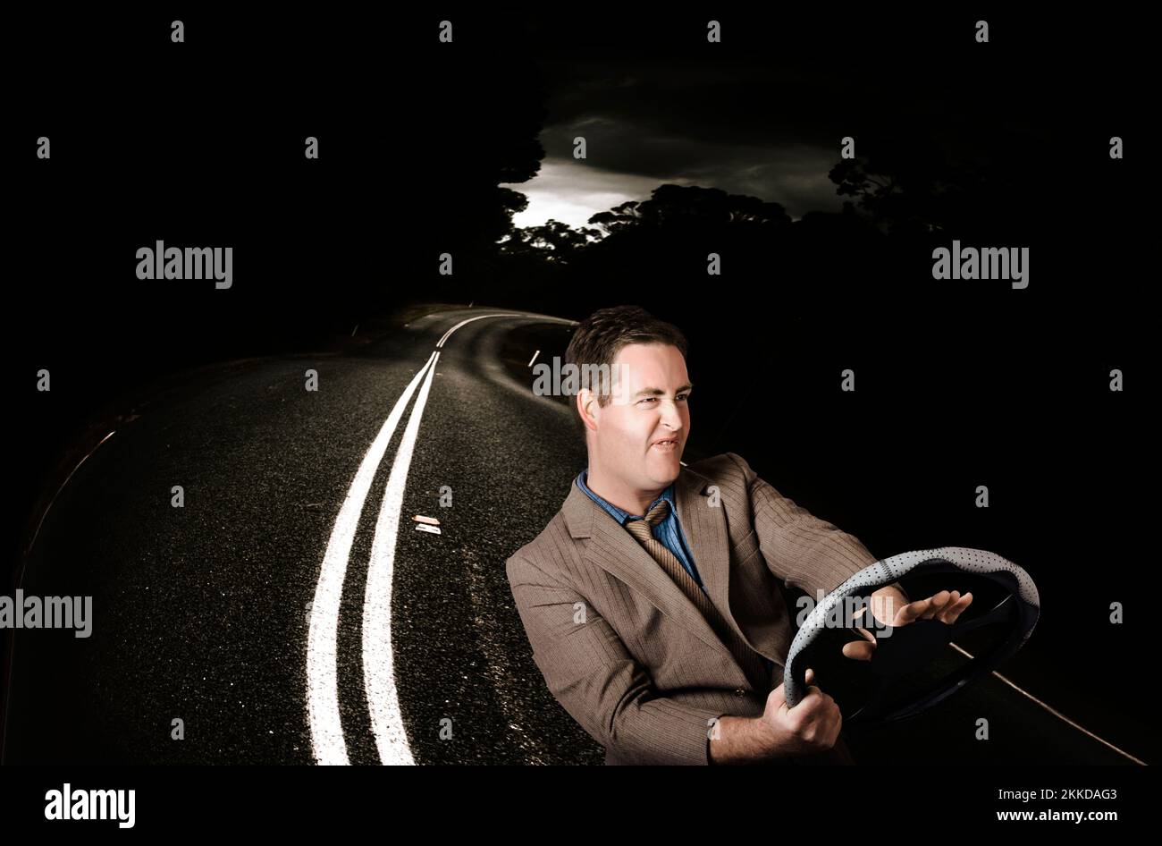 Road rage man beeping horn while behind the wheel of a vehicle on a dark road. Car accident