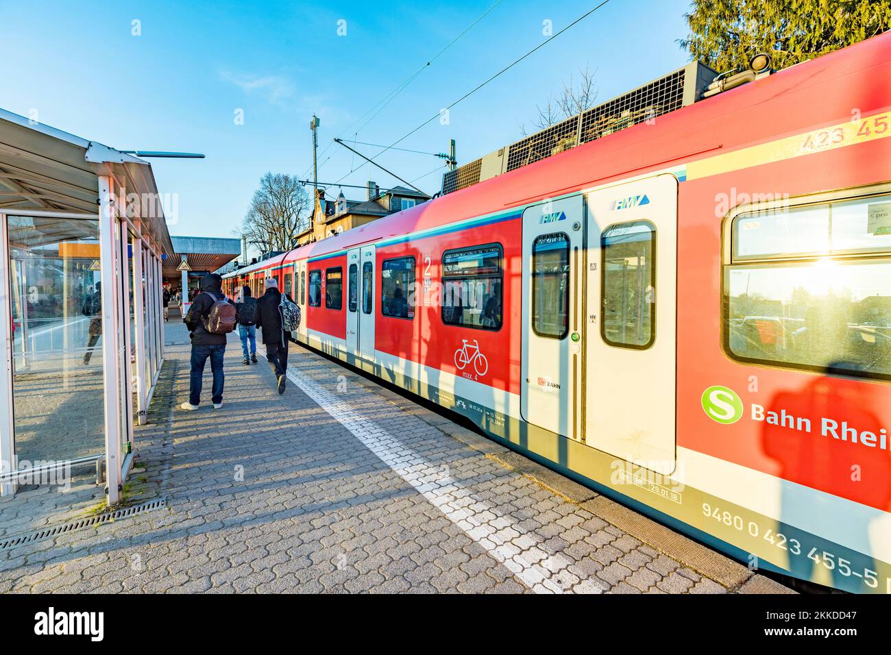 Eschborn, Germany - February 27, 2018:  people waiting outside at the trai platform of  the S-Bahn, the public transportation system in Frankfurt for Stock Photo