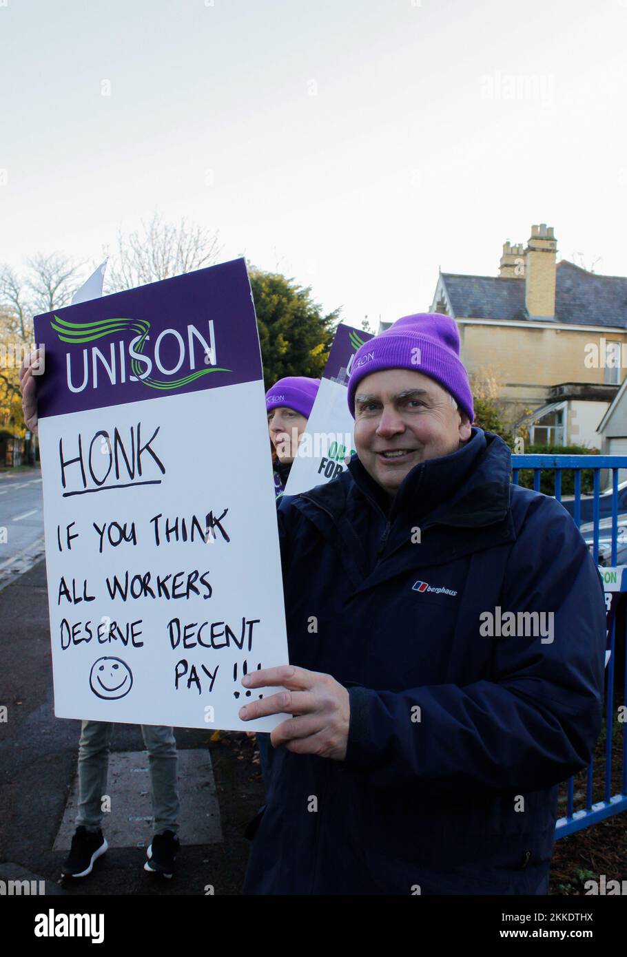 Cheltenham, UK. 25th Nov, 2022. Man holds a written sign on the side of a busy road outside park university campus in Cheltenham with other members of the unison group on the 25th november 2022 Credit: Pathos Images/Alamy Live News Stock Photo