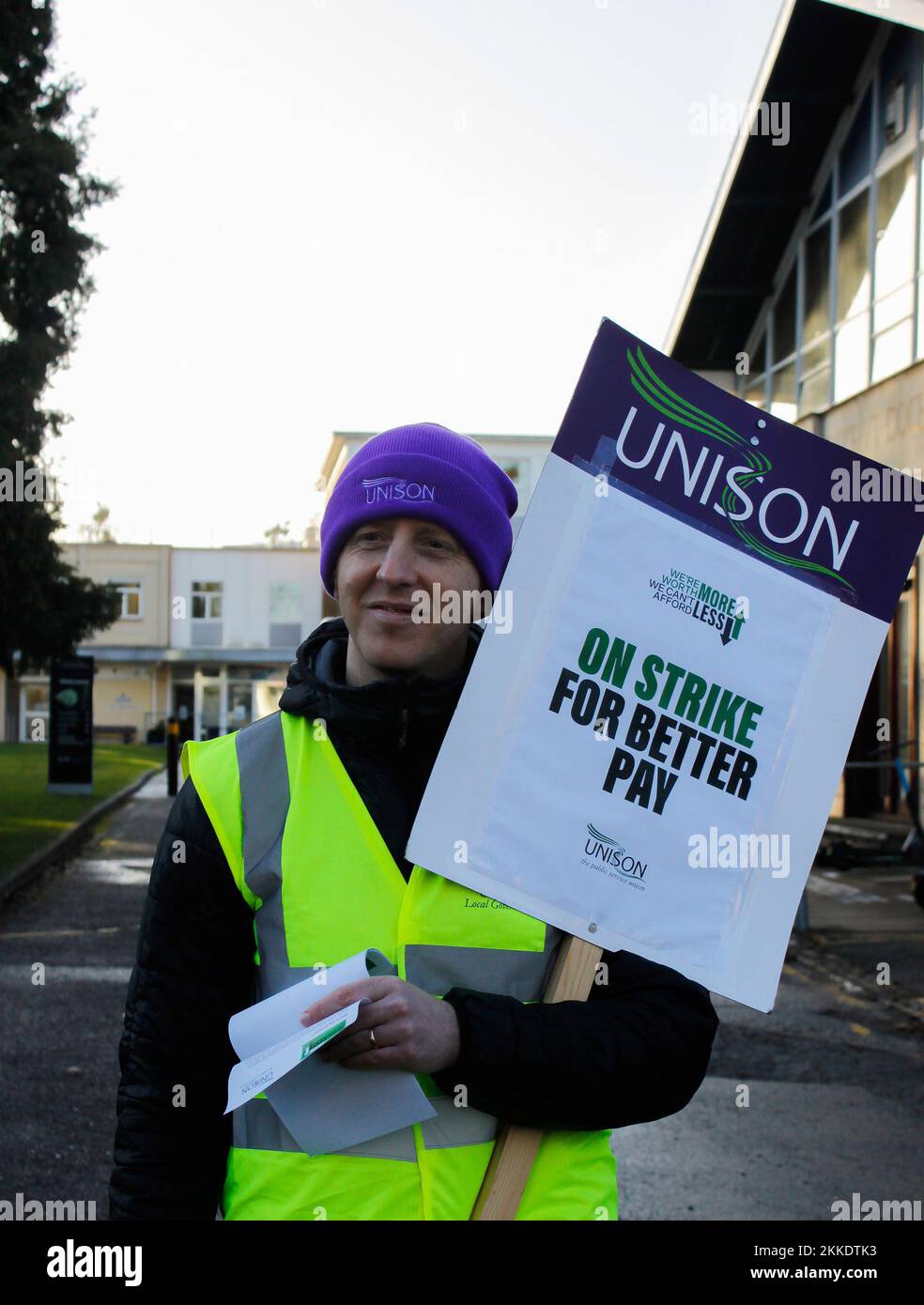 Cheltenham, UK. 25th Nov, 2022. Man holds a written sign on the side of a busy road outside park university campus in Cheltenham with unison group on 25th november 2022 Credit: Pathos Images/Alamy Live News Stock Photo