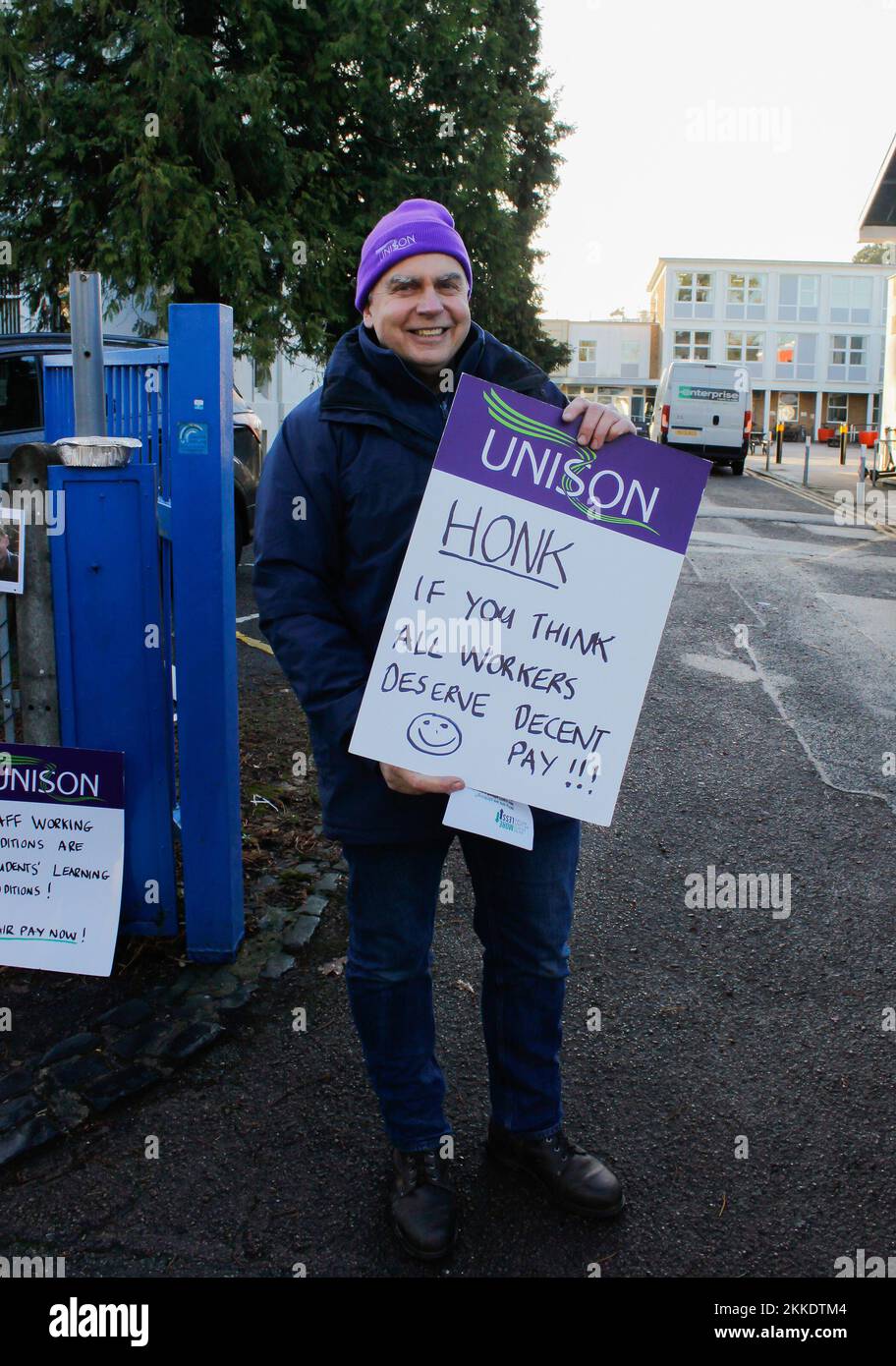 Cheltenham, UK. 25th Nov, 2022. Man holds a written sign on the side of a busy road outside park university campus in Cheltenham with unison group on 25th november 2022 Credit: Pathos Images/Alamy Live News Stock Photo