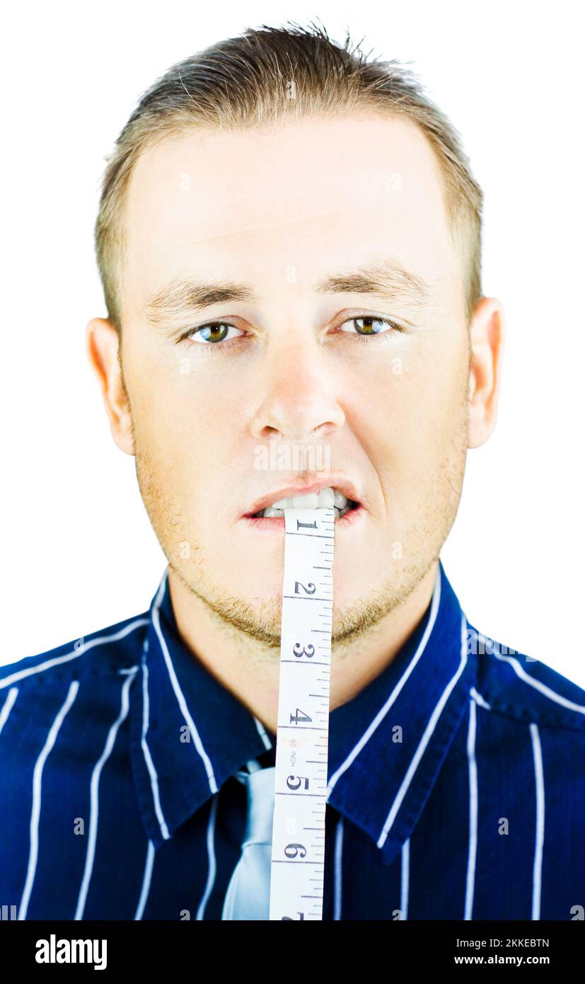 Man biting and holding tape measure in mouth on white background Stock