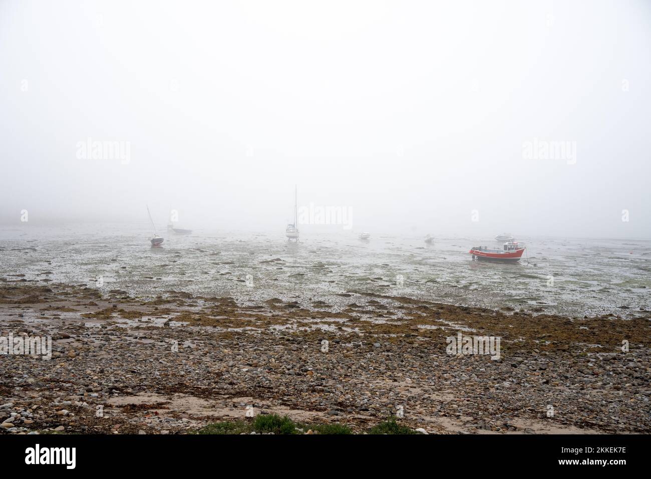 A beautiful view of docked boats on a foggy day from a shore Stock ...