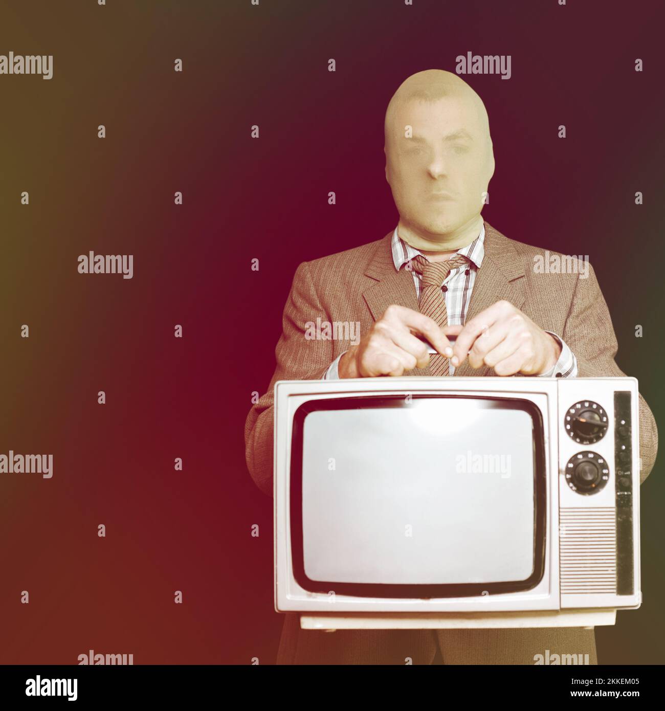 Burglar in a stocking mask and suit stealing an old retro television