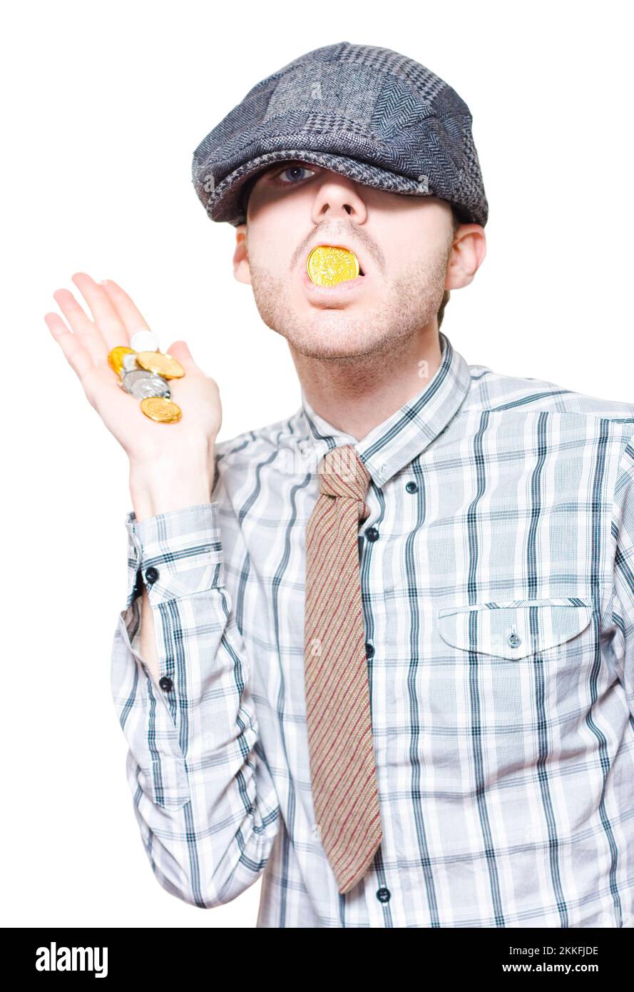Unethical Business Person Eating Gold Coins When Hiding Financial Gains From The IRS Tax Department In A Money Laundering Concept On White Stock Photo