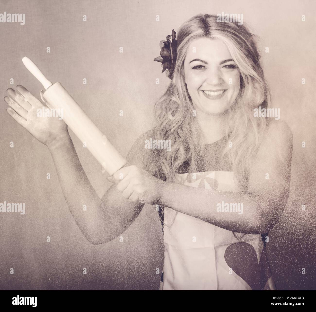 Vintage rolling pin up girl making cooking fun with baking utensils and