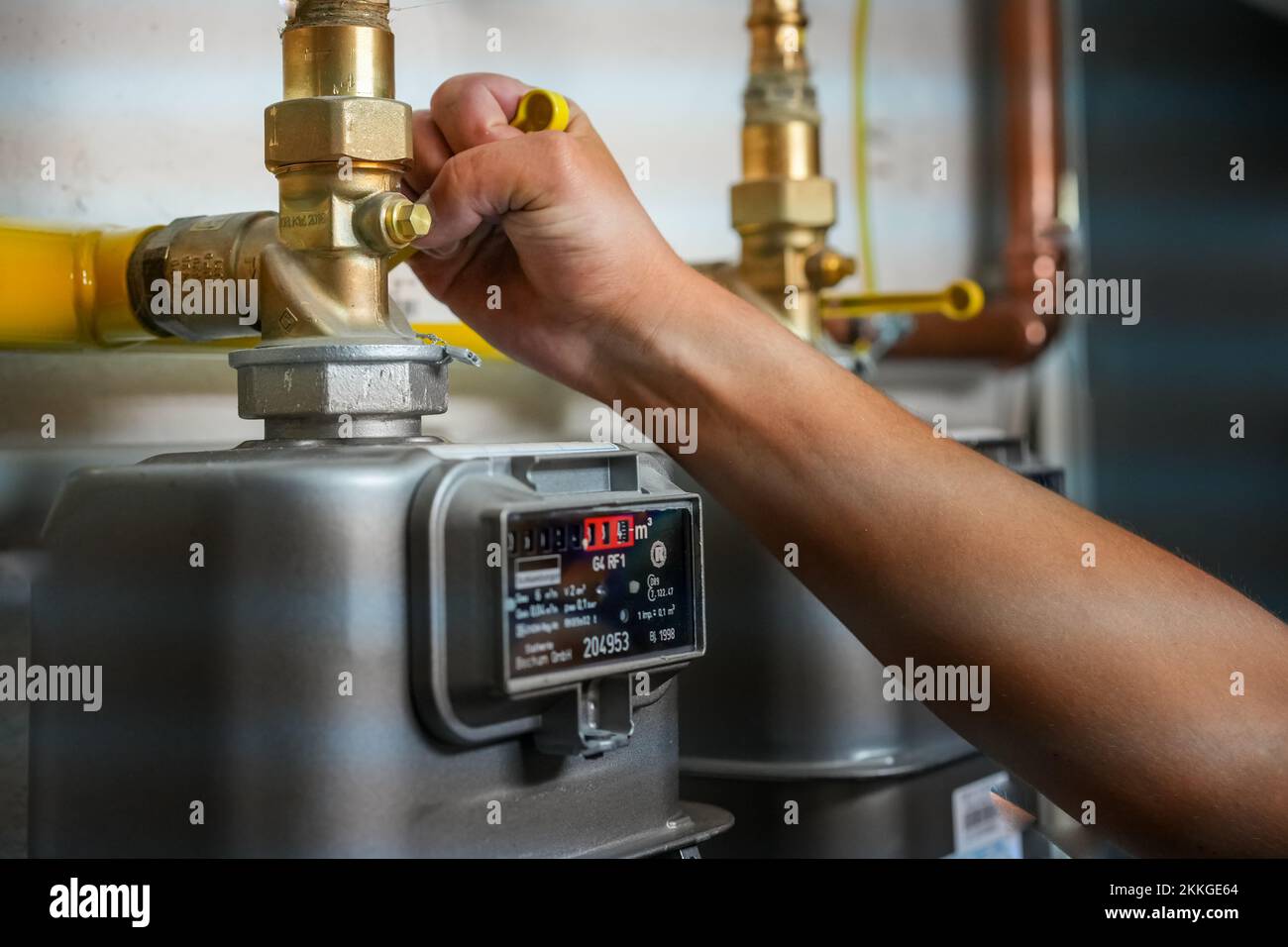 A person adjusting a gas meter to reduce gas usage inflation, energy