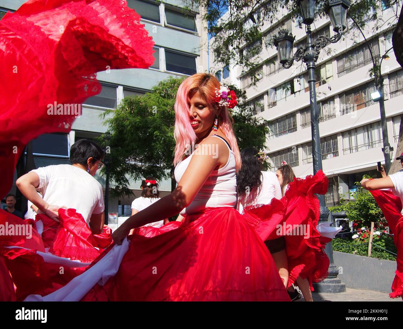 Women from 'Red Tide' activist group performing in red skirts in the street of Lima as part of the activities of the International Day for the Elimination of Violence against Women, an event that is commemorated annually on November 25, the date on which the three Mirabal sisters (Patria, Minerva and María Teresa) were murdered. in the Dominican Republic on 1960. Credit: Fotoholica Press Agency/Alamy Live News Stock Photo