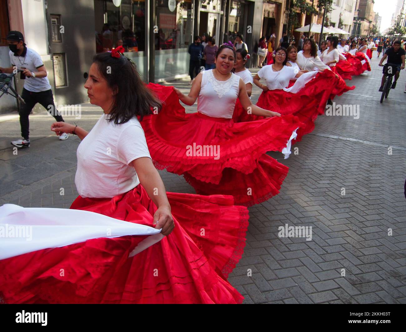 Women from 'Red Tide' activist group performing in red skirts in the street of Lima as part of the activities of the International Day for the Elimination of Violence against Women, an event that is commemorated annually on November 25, the date on which the three Mirabal sisters (Patria, Minerva and María Teresa) were murdered. in the Dominican Republic on 1960. Credit: Fotoholica Press Agency/Alamy Live News Stock Photo