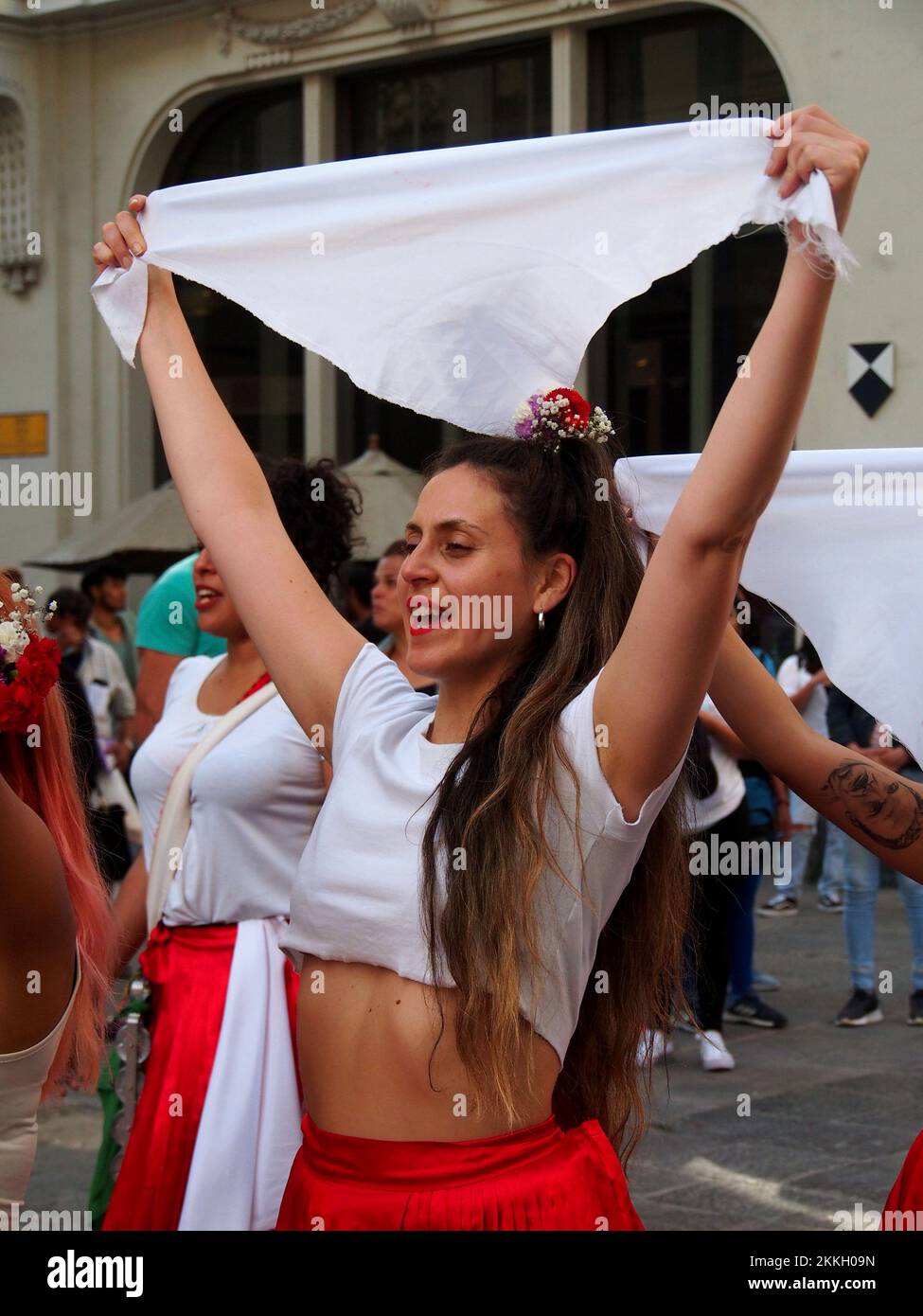 Girls waving white scarves when women from 'Red Tide' activist group performing in red skirts in the street of Lima as part of the activities of the International Day for the Elimination of Violence against Women, an event that is commemorated annually on November 25, the date on which the three Mirabal sisters (Patria, Minerva and María Teresa) were murdered. in the Dominican Republic on 1960. Credit: Fotoholica Press Agency/Alamy Live News Stock Photo