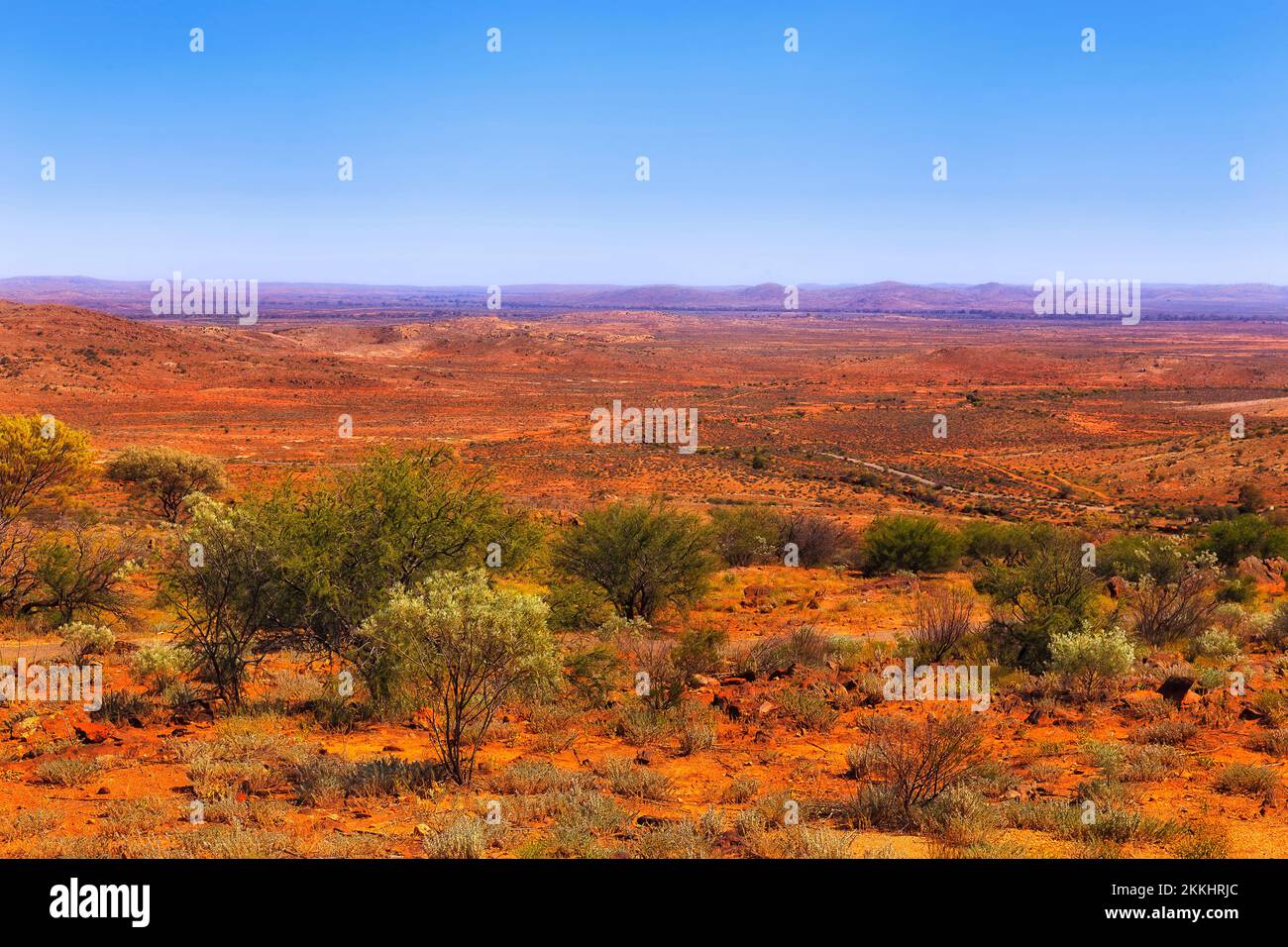 Scenic bright arid red soil landscape of Australian outback desert around Broken Hill city in NSW on a hot summer day. Stock Photo