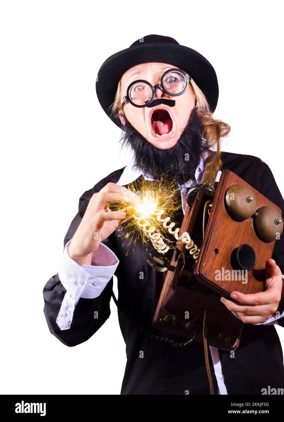 Strange looking woman in black hat, false beard and jacket holding antique telephone and receiving violent electric shock Stock Photo