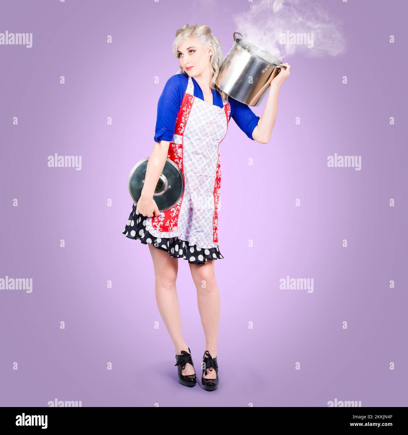 Young pinup woman cooking healthy food in a steam stock pot on purple