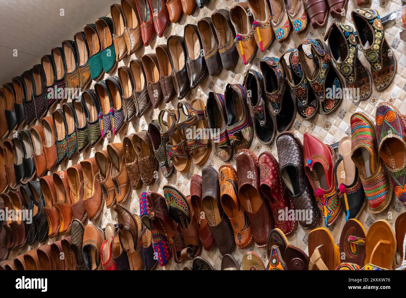 Colorful Rajsathani ladies shoes are being sold at famous Sardar Market and Ghanta ghar Clock tower in Jodhpur, Rajasthan, India. Stock Photo