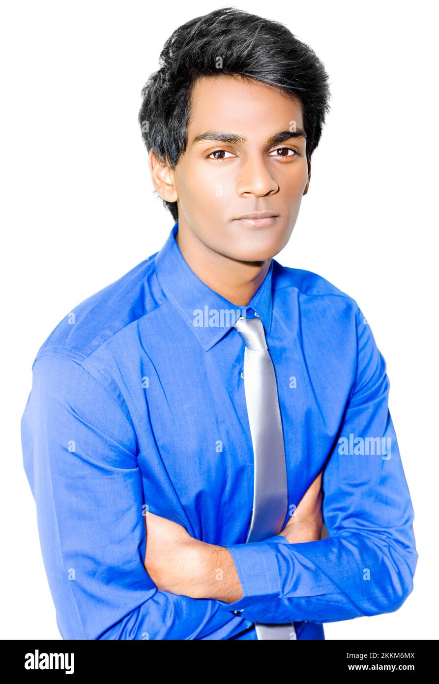 Successful young Asian entrepeneur staring earnestly at the camera with his arms crossed as he listens intently on white background Stock Photo