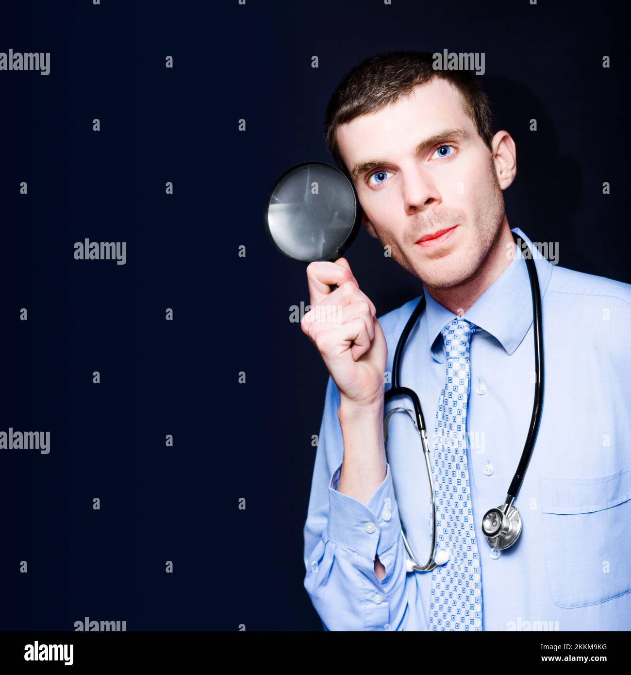 Male Medical Doctor Thinking With Magnifying Glass To Head In A