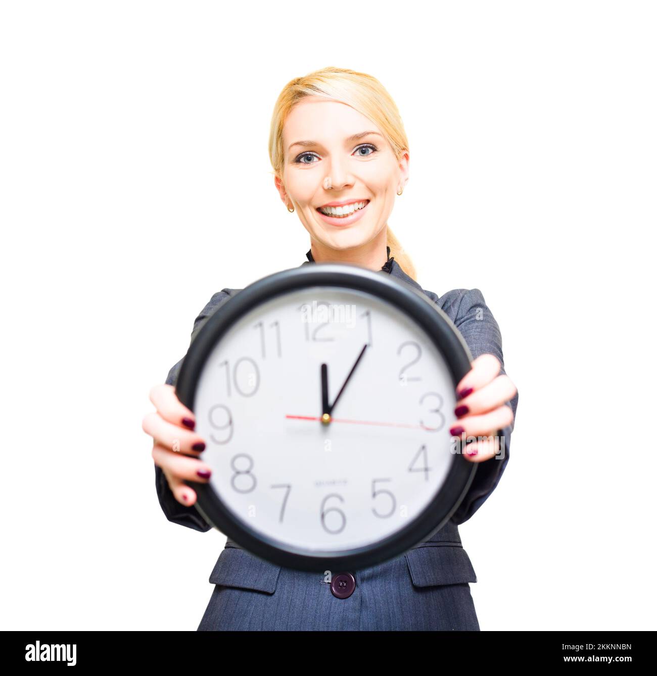 Confident Friendly Young Caucasian Business Woman Holding A Large Clock In Hands Showing The