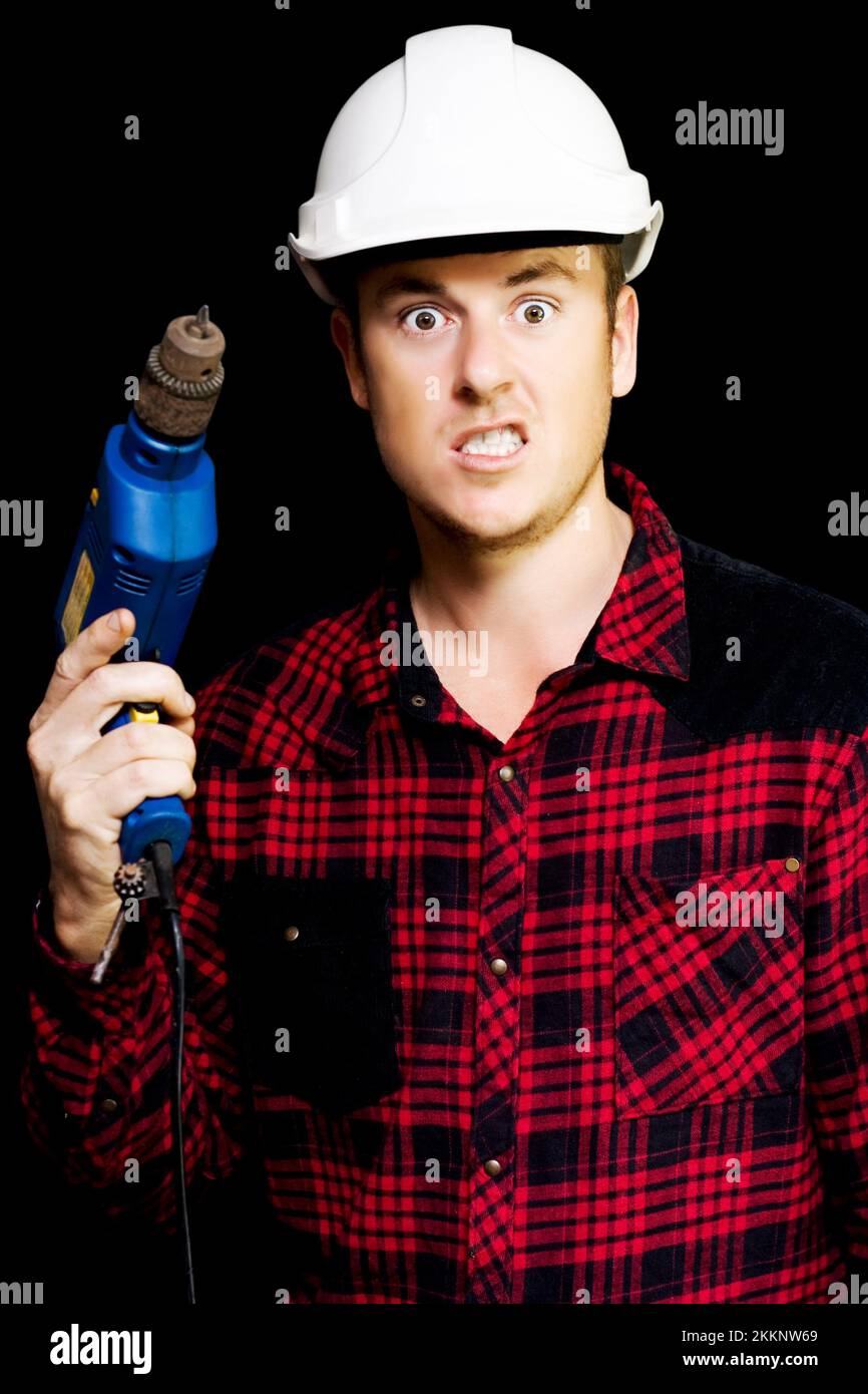 Furious out of control construction site worker snarling in fury as he threateningly raises his