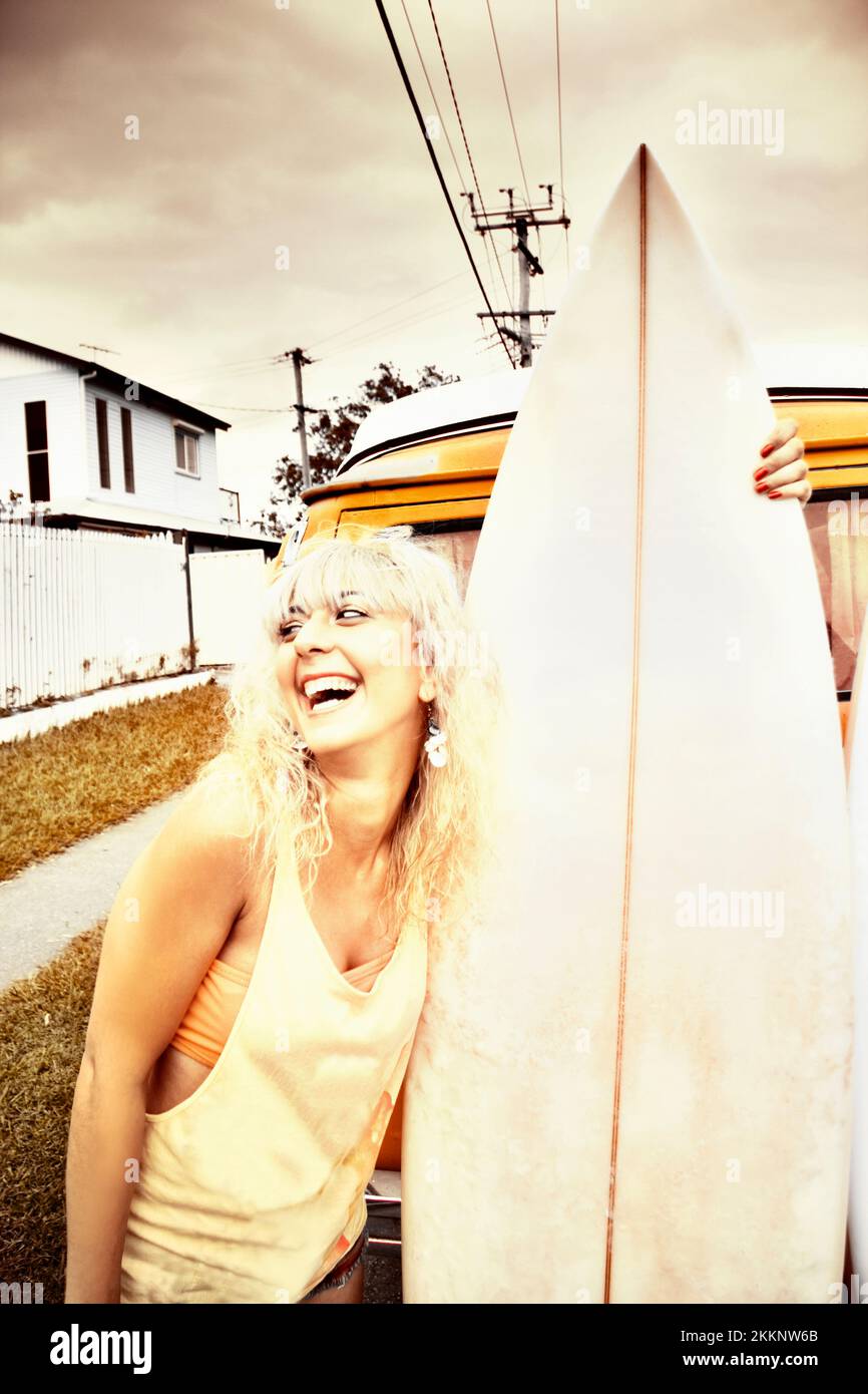 Happy Retro Surfer Laughs Out Loud With A Open Mouth Smile In A Grunge Desaturated Image Replicating The Surf Lifestyle Of The 1970s Stock Photo