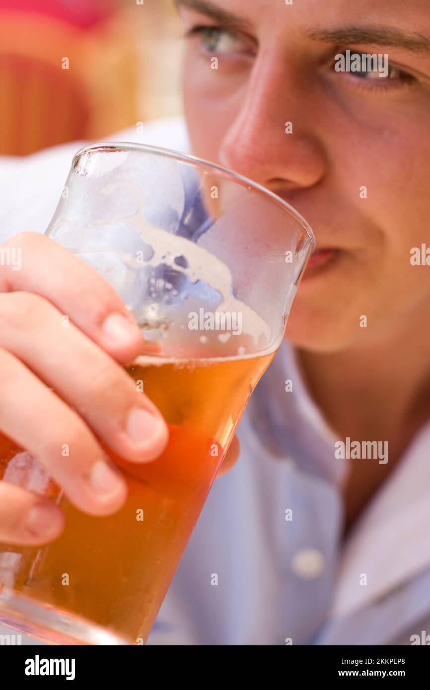 Contemplation Consumes The Face Of A Cider Drinker Half Way Though His