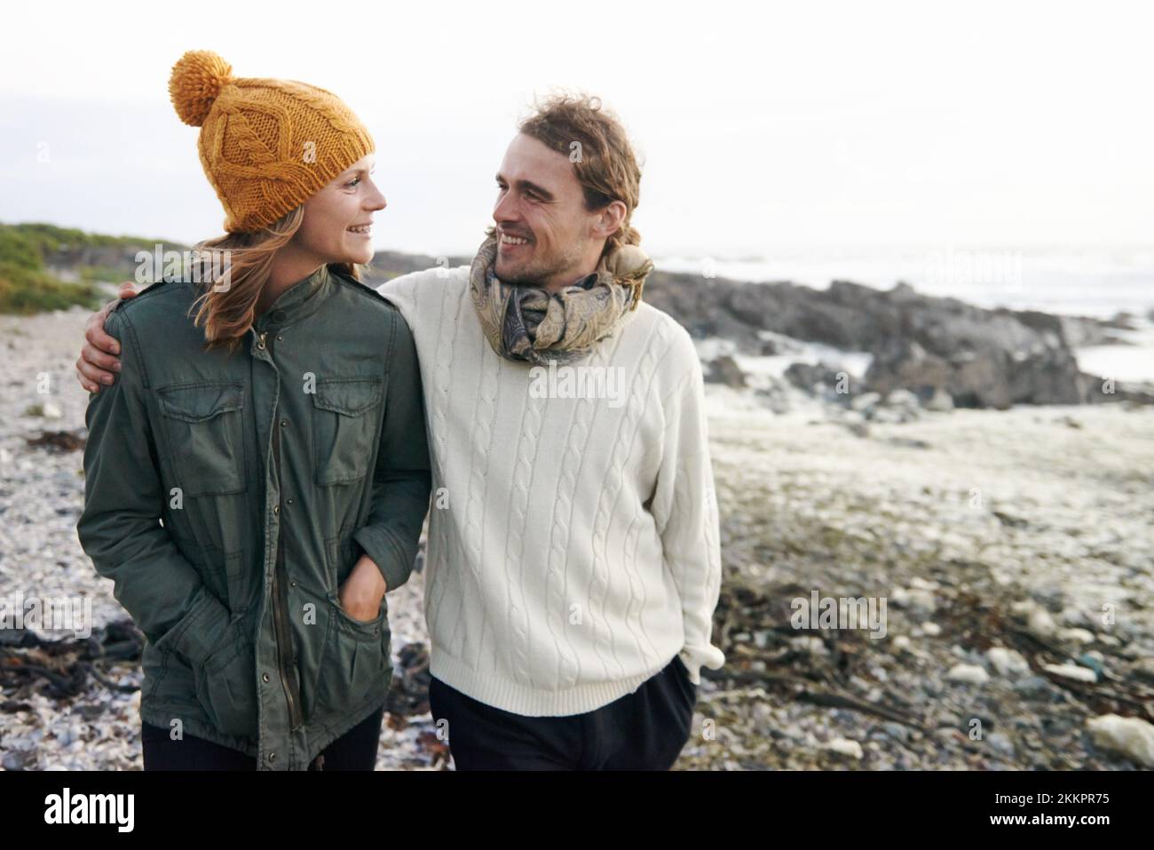 We love long walks on the beach. an affectionate young couple taking a