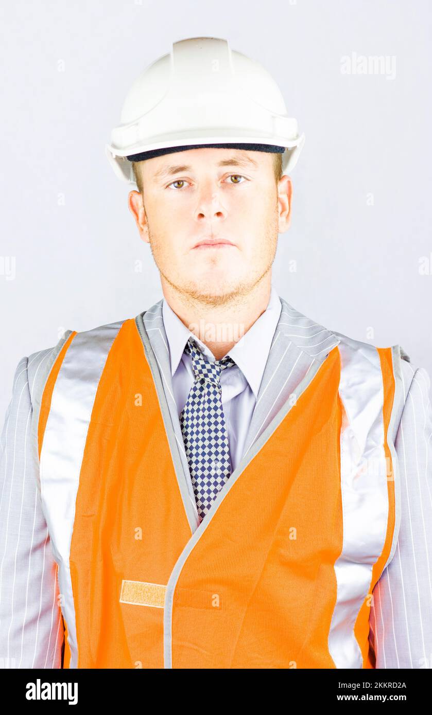 A serious responsible young man in the high visibility orange jacket