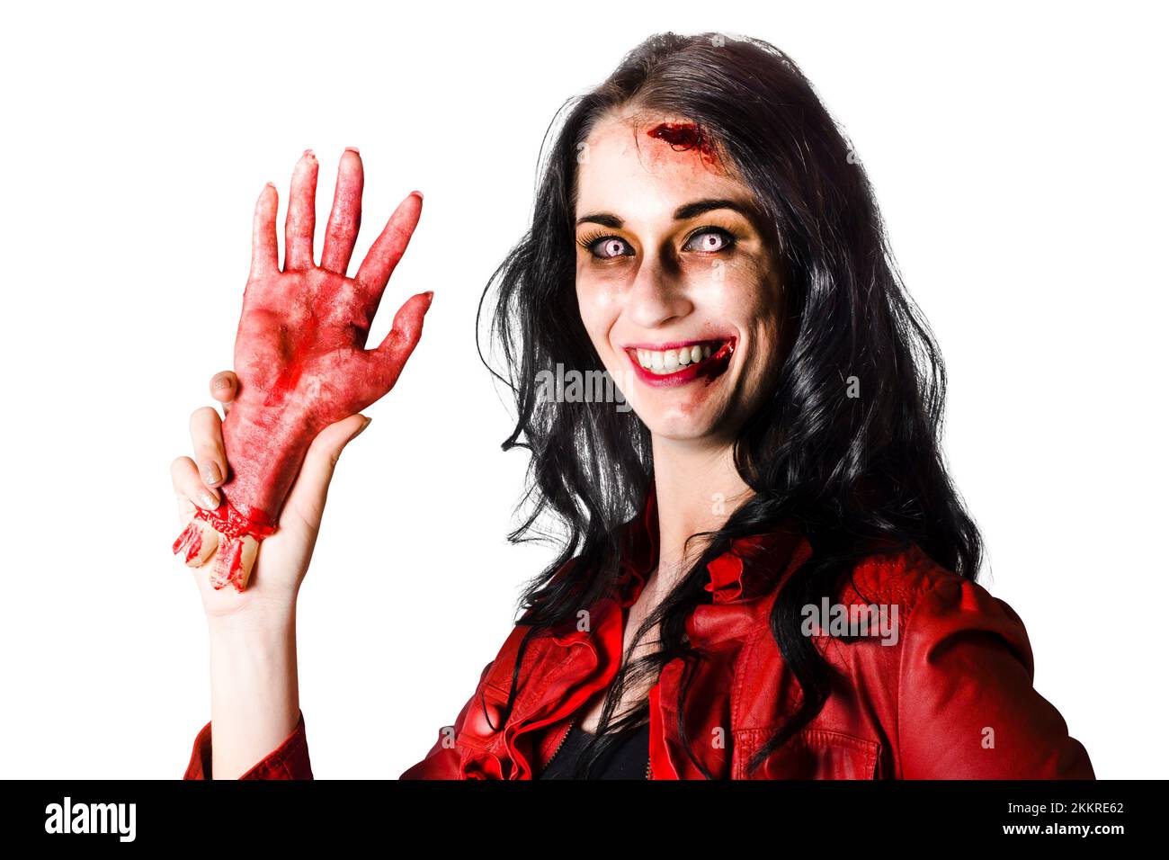 Smiling zombie woman holding a bloody severed hand when welcoming you to  halloween Stock Photo - Alamy