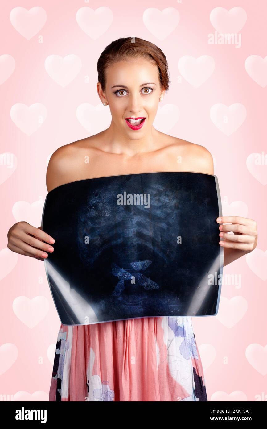 Love Struck Woman Holding XRay Showing Butterflies Flying In Her