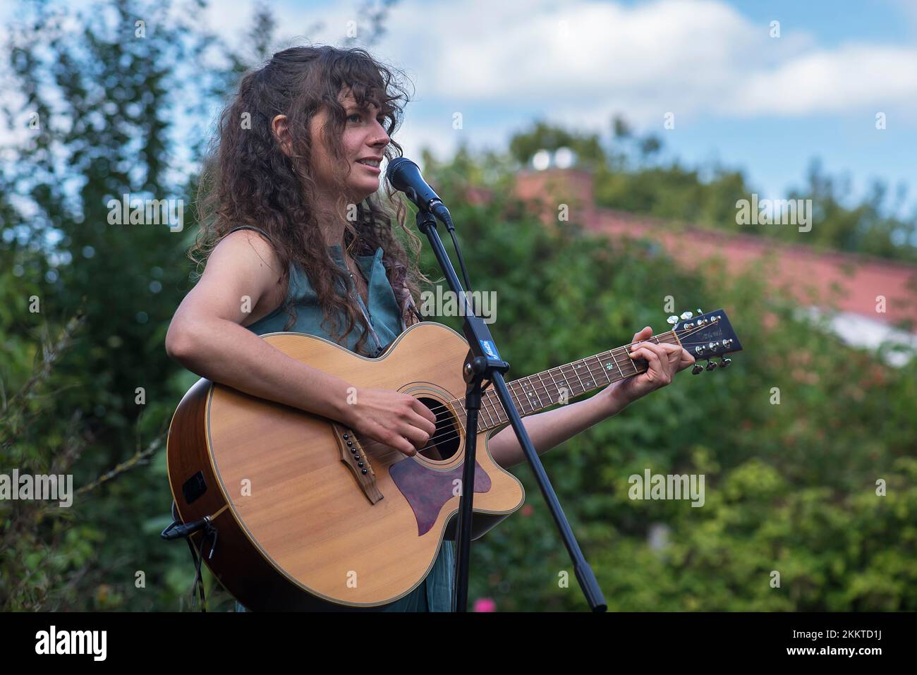 Young woman singing and playing the guitar, Lower Saxony, Germany, Europe Stock Photo