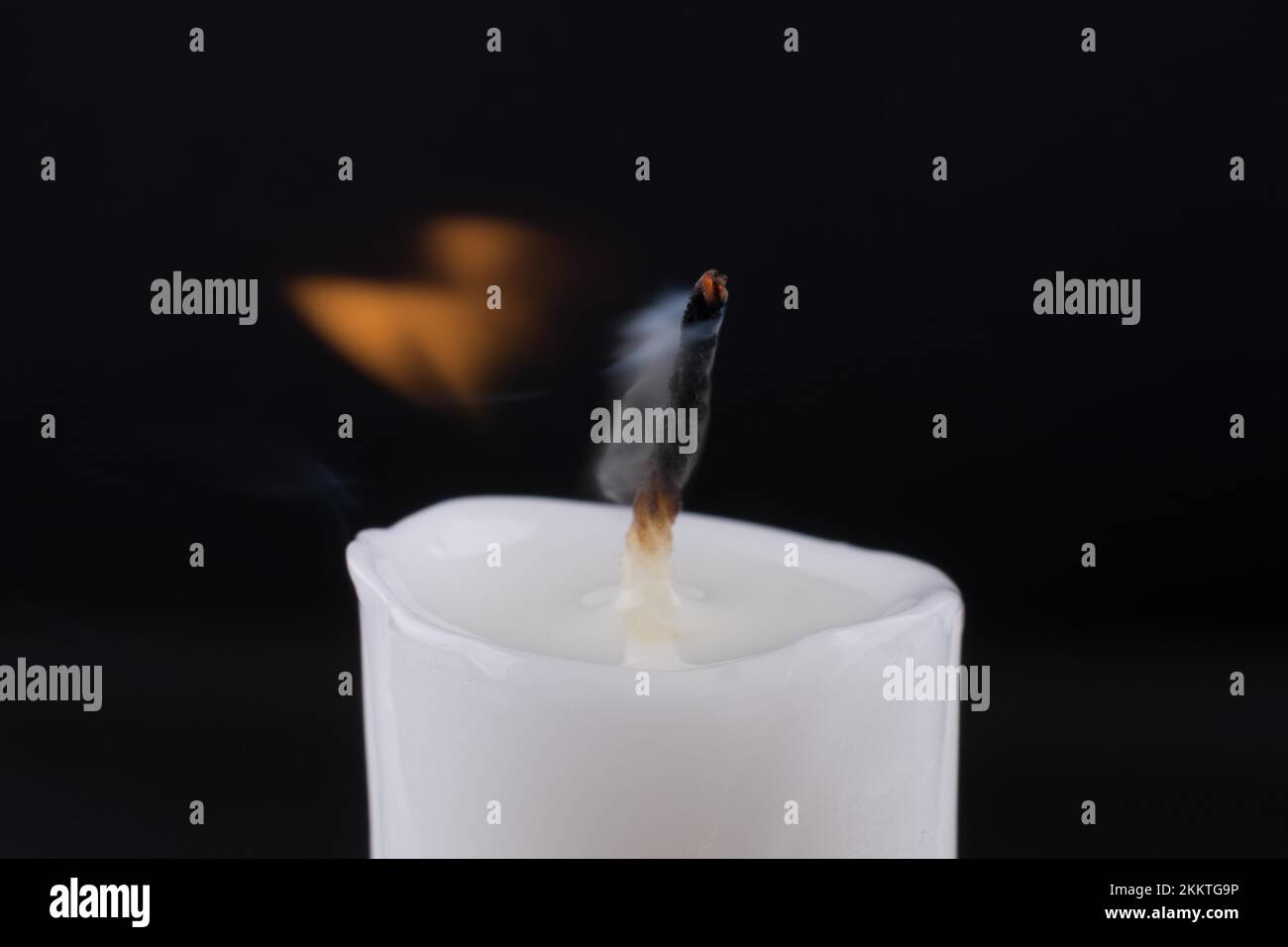Burning white candle on a black background Stock Photo - Alamy
