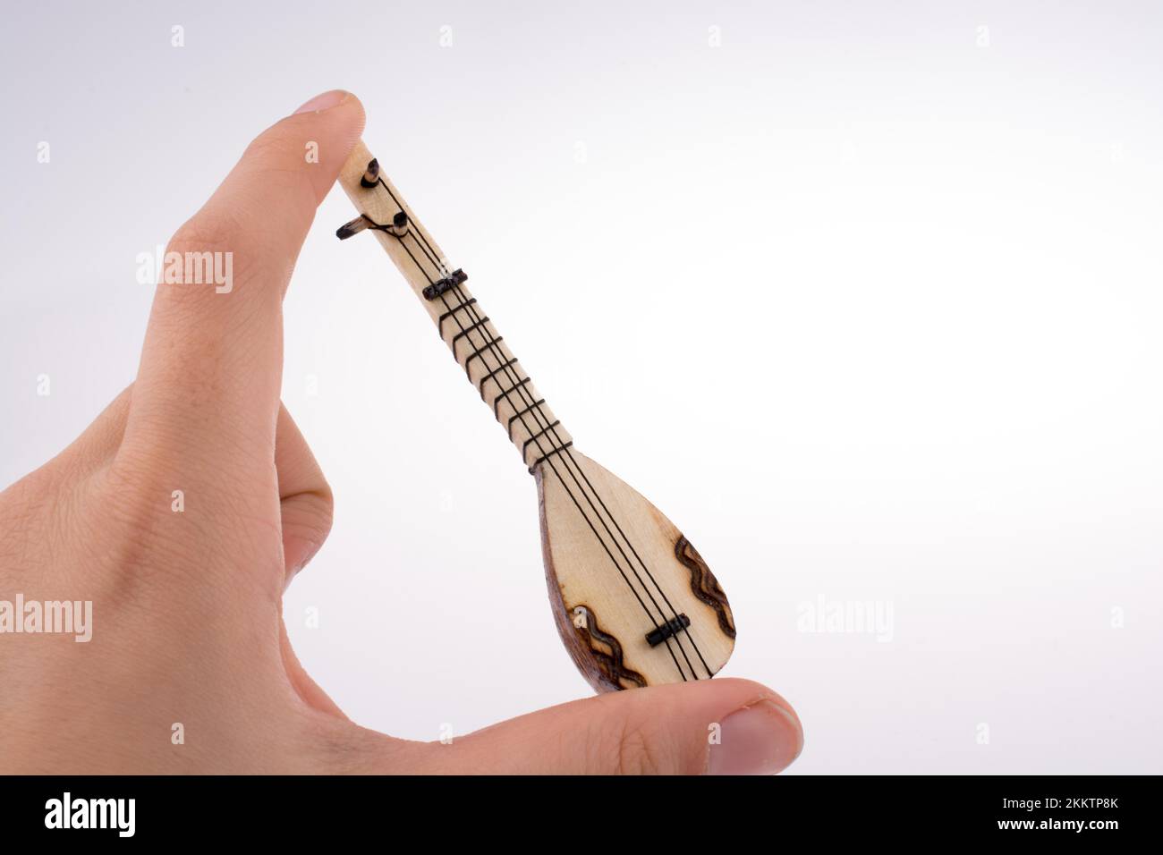 Hand holding the classic turkish instrument Saz Stock Photo Alamy