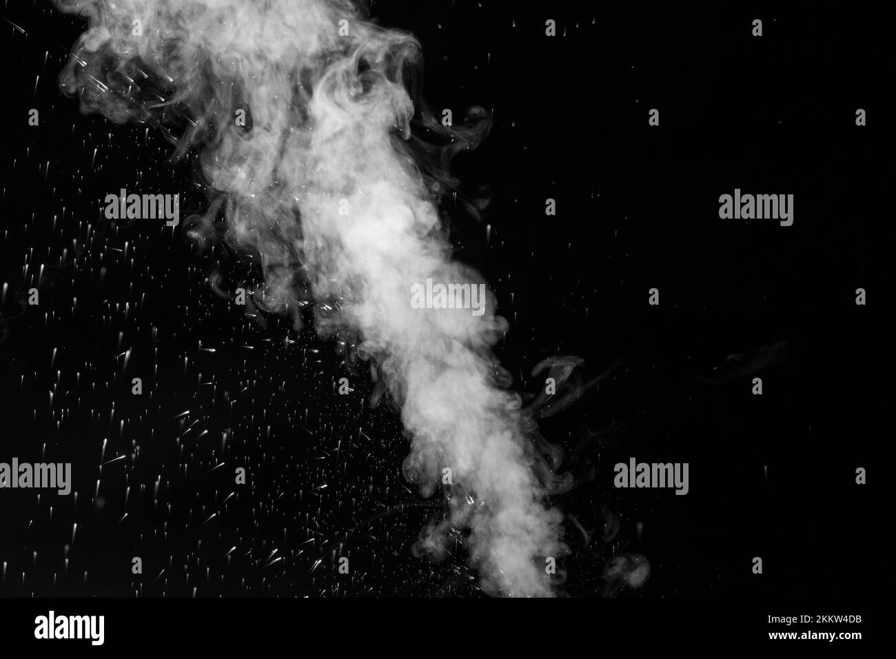 A jet of hot steam with splashes. The movement of hot steam with water droplets is highlighted on a black background to overlay your photos. Steam bac Stock Photo