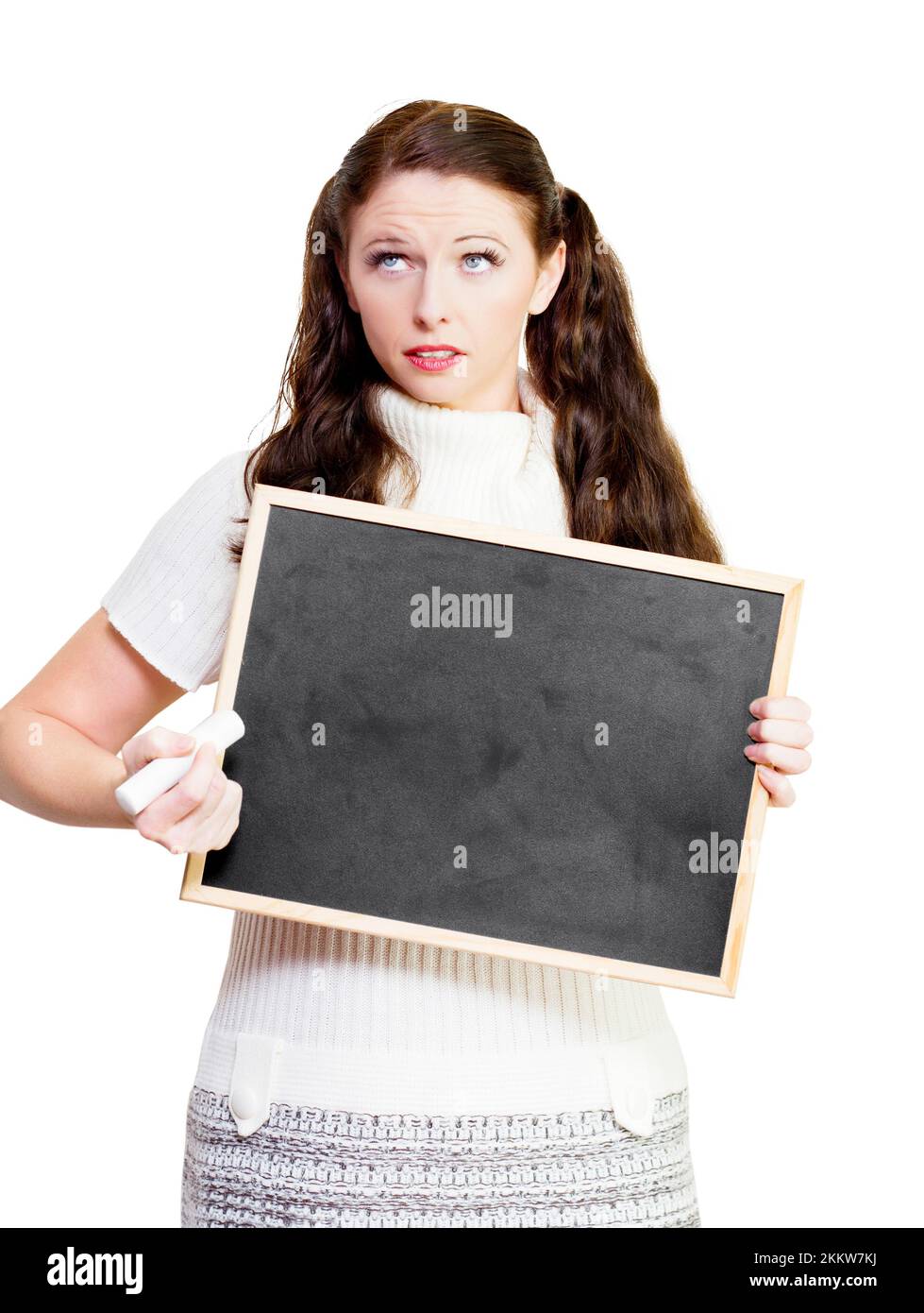 Teacher thinking of solutions to education problems while holding a black chalk board or blackboard with space for your educational message, on white Stock Photo